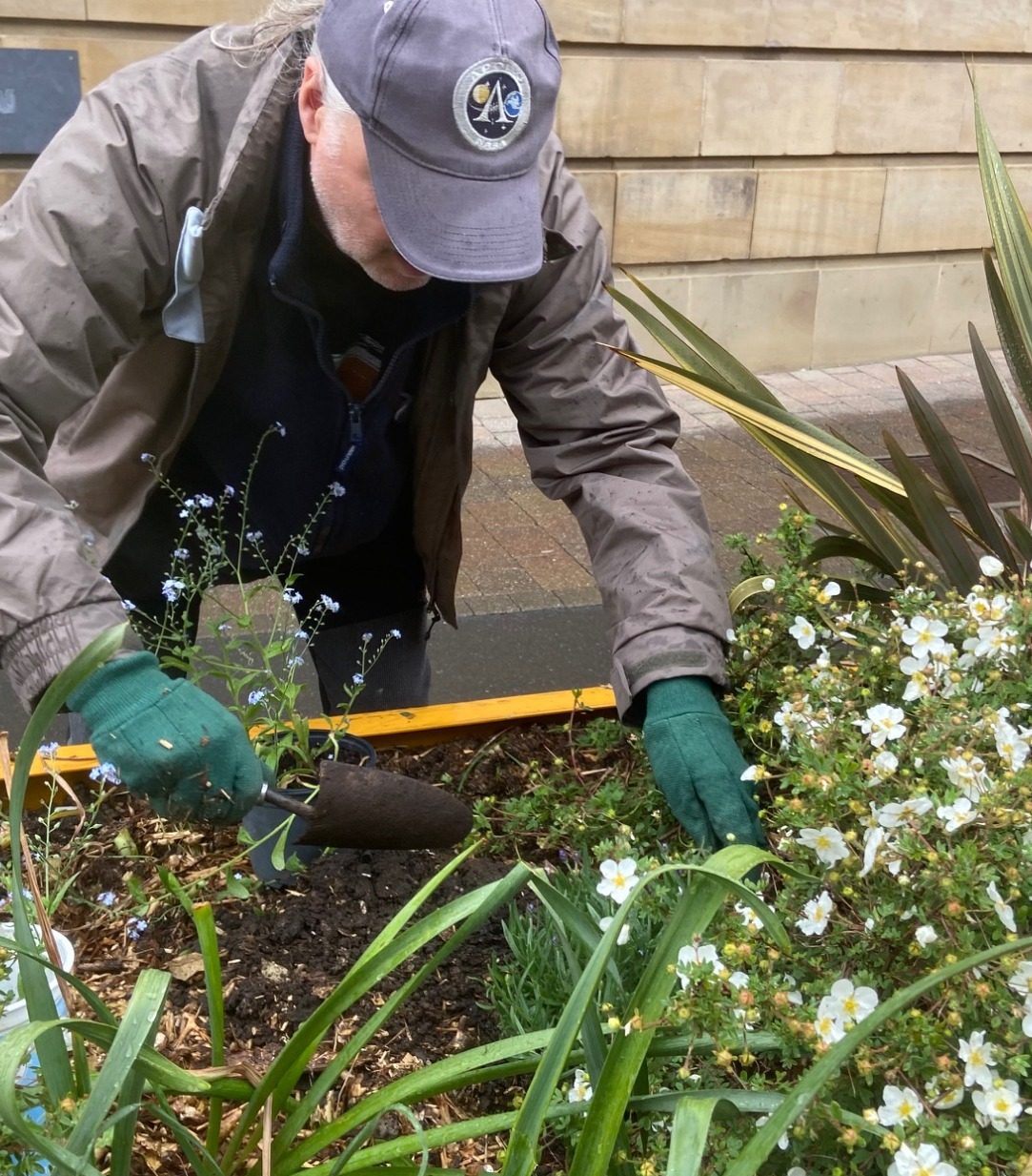 Blooming marvellous 
on this damp May Day the
Friends of Castleford library planting to brighten up the flower tubs outside the library.
